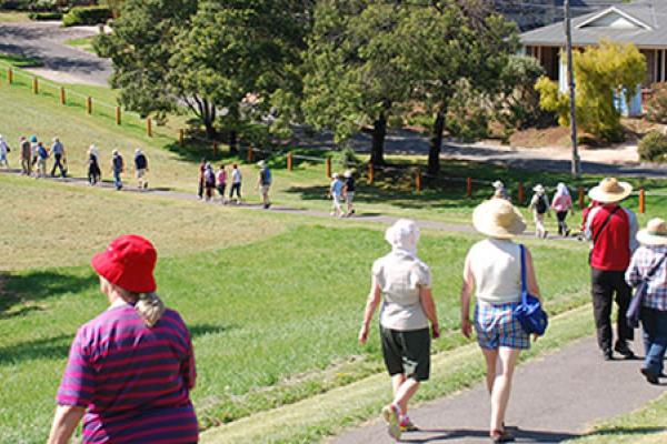 Photo of people walking through Ruffey Lake Park path